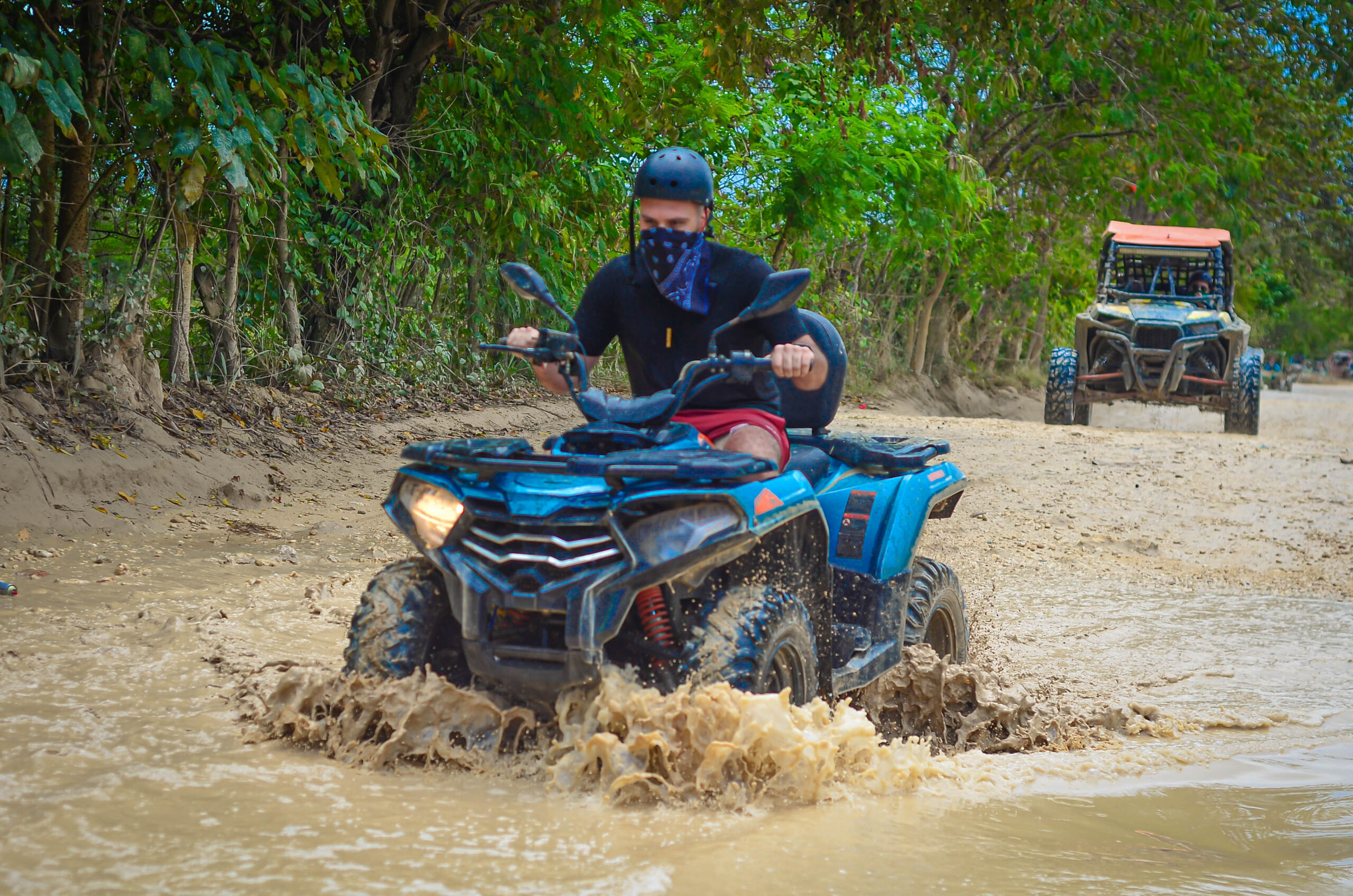 Buggy riding through muddy tropical trail